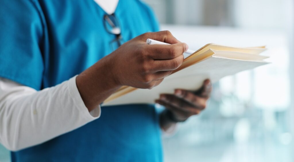 Chiropractor reviewing chiropractic injury documentation for personal injury case at Back In Motion Group Brooklyn NY
