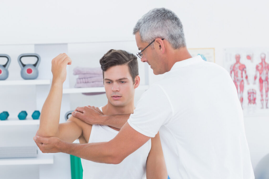 Chiropractor testing a patient's arm strength and function to evaluate maximum medical improvement