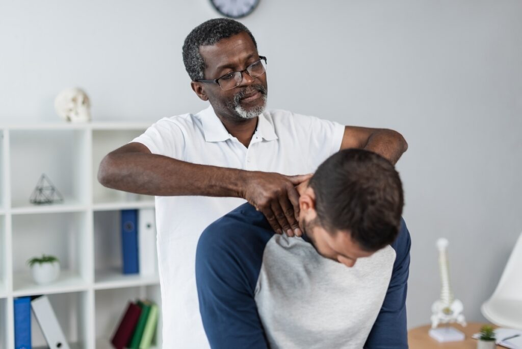 Chiropractor performing a cervical spine adjustment on a patient injured in a car accident covered by no-fault insurance